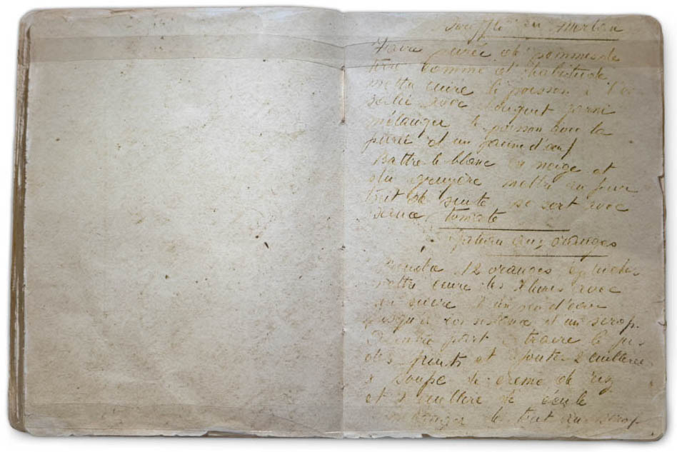 An old book, open to a handwritten page, difficult to make out, in French.