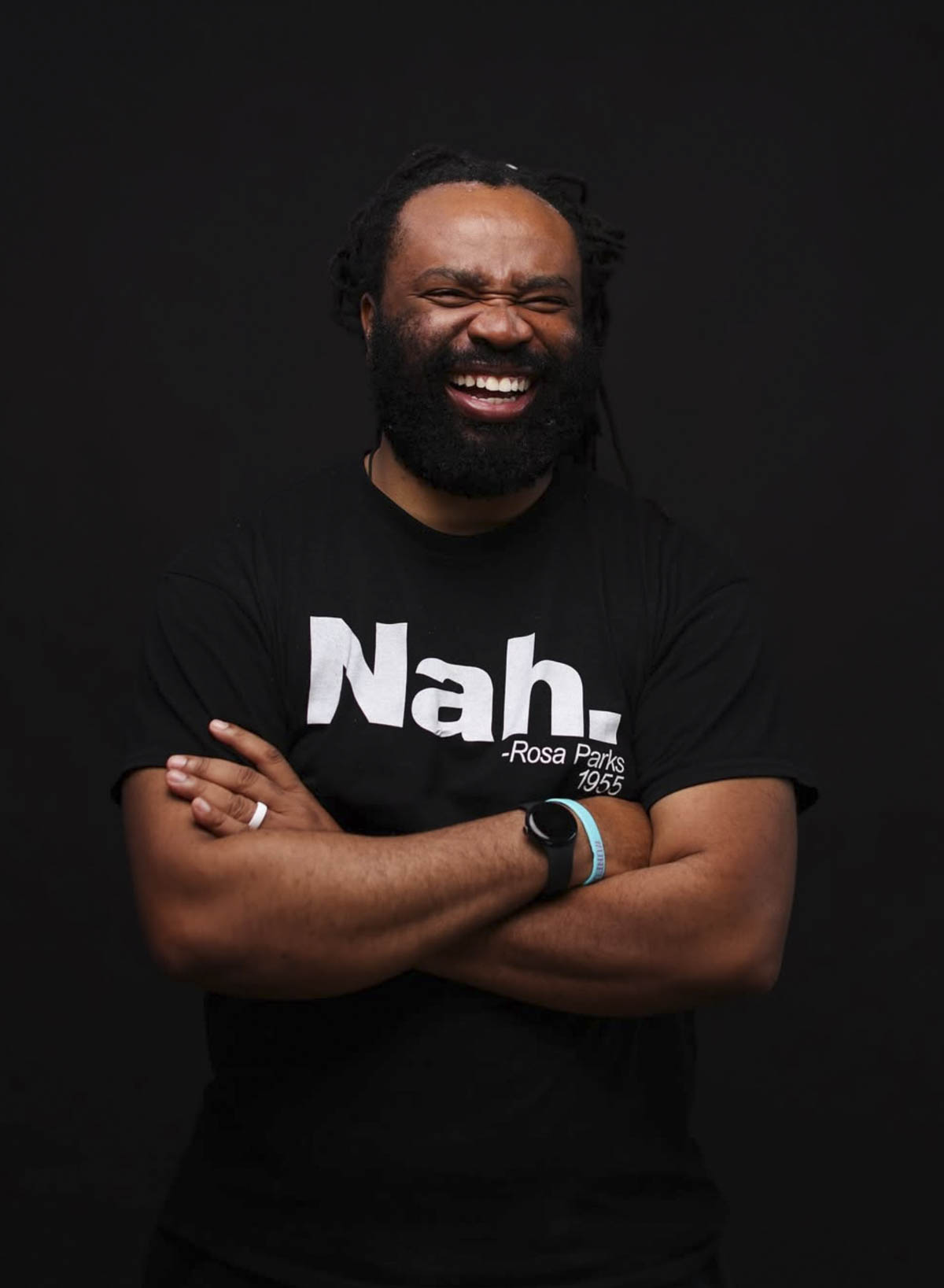 A bearded Black man with an enormous smile.