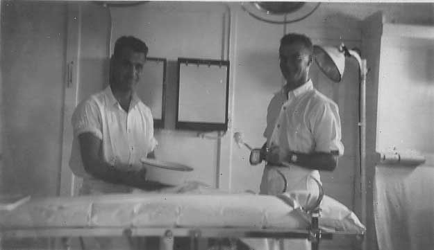 Two men standing behind an operating table are looking at the camera.