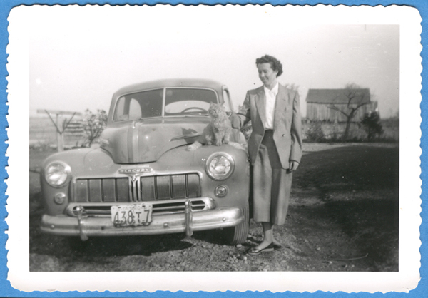 Grace Veenstra with family car, 1951 c. Canadian Museum of Immigration at Pier 21 (DI2013.1772.12). 