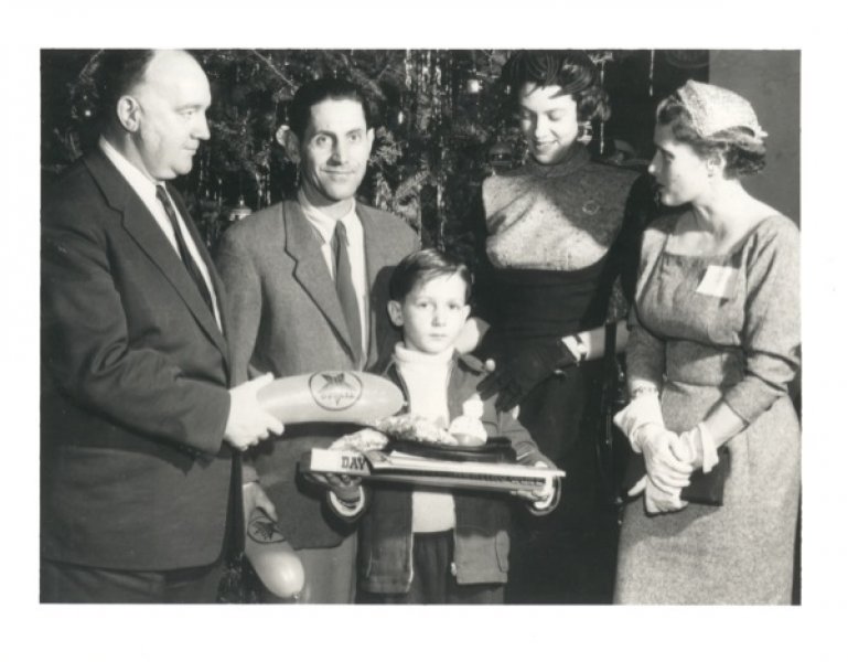 First Hungarian refugees with Immigration officer William A. McFaul during Christmas, Montreal, Quebec, 1956. Canadian Museum of Immigration at Pier 21 (D2014.10.10).