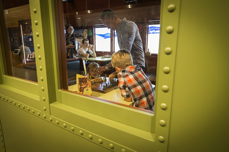 Children are playing inside a replica of a train’s car.