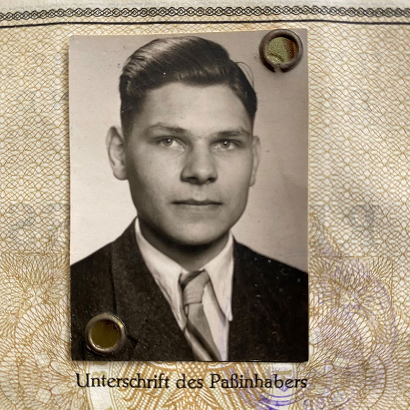 Passport photo of a young man in a suit.