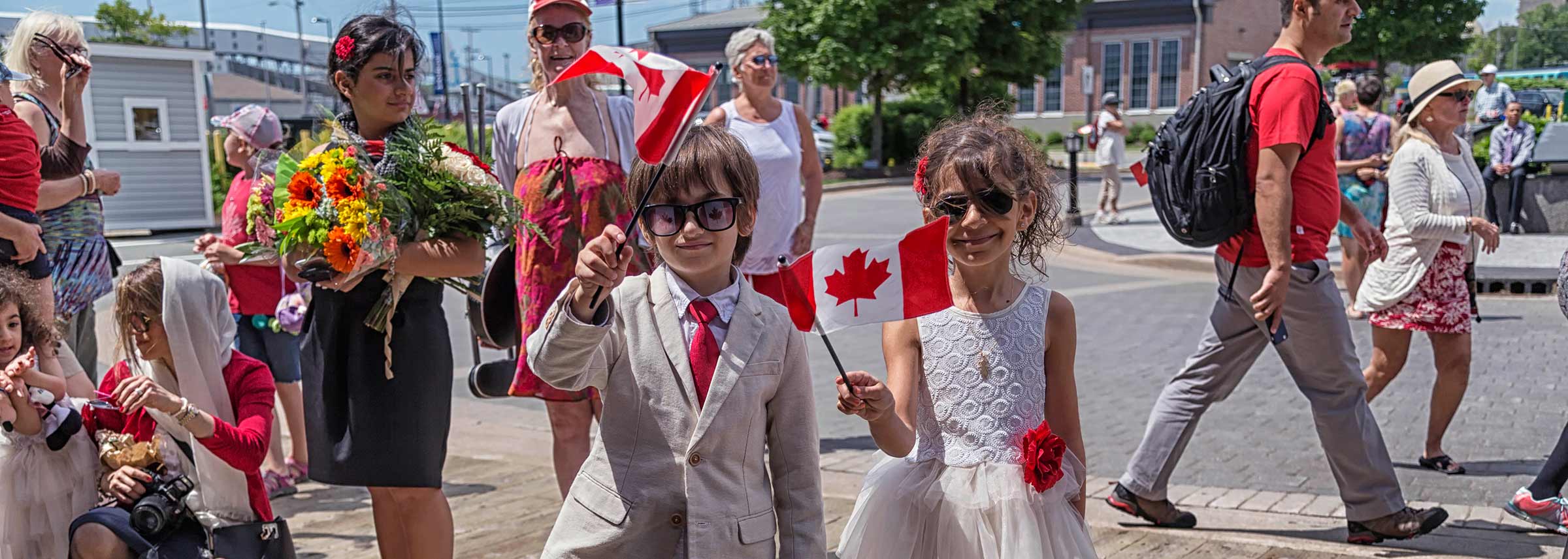 A boy and girl dressed in red and white for Canada Day celebrations