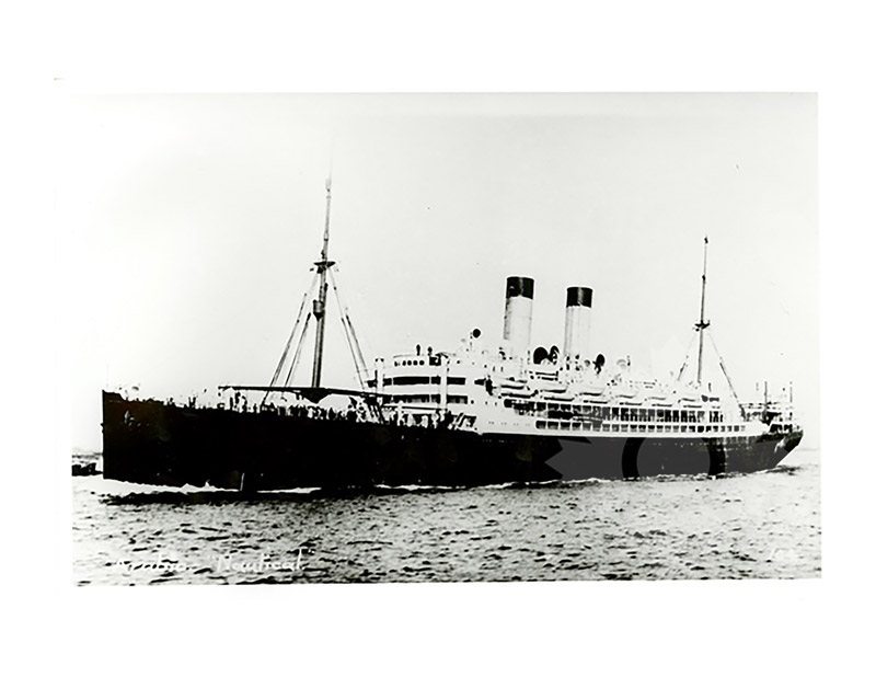 Black and white image of SS Arabic III at sea, seen broadside from port, twin funnels and masts visible.