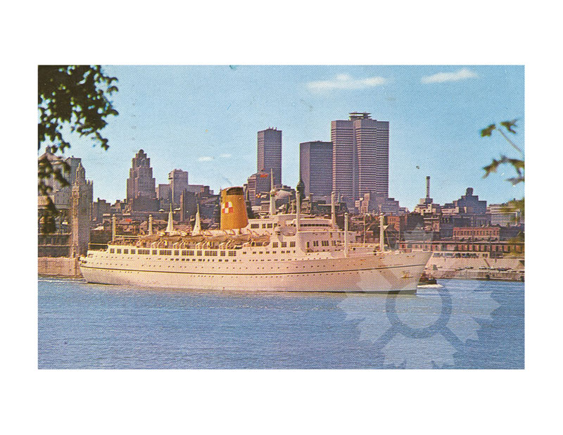 Colour photograph of RMS Empress of Britain docked in harbour, broadside from port, with a city skyline behind.