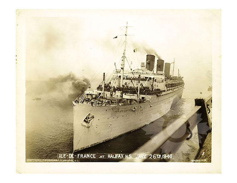 Sepia-toned image of SS Île de France arriving at Halifax, from the starboard bow, crowded decks and funnels smoking.