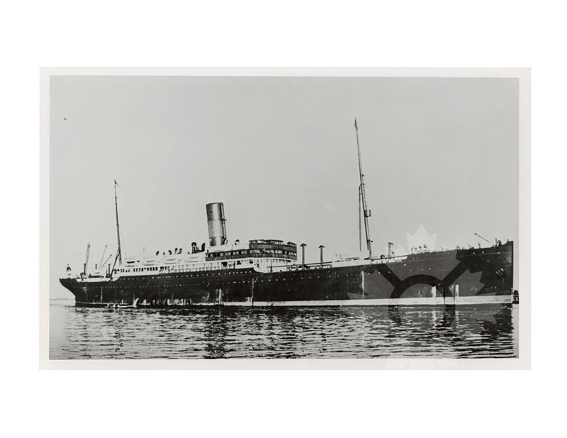 Black and white image of SS United States I at anchor, broadside from port, single funnel and two masts visible.