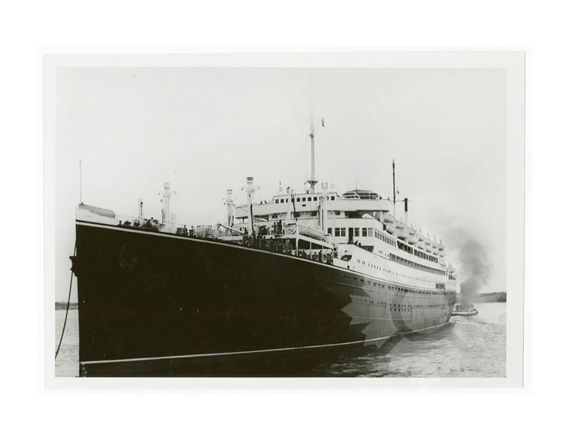 Black and white image of MS Vulcania in harbour, seen close up from the port bow.