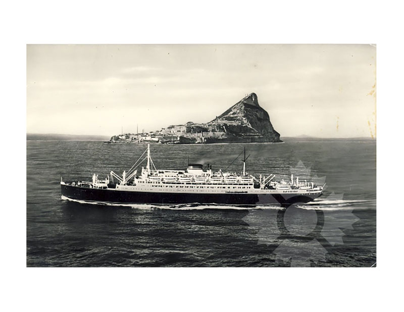 Black and white image of MS Vulcania at sea, broadside from port, with the Rock of Gibraltar in the background.