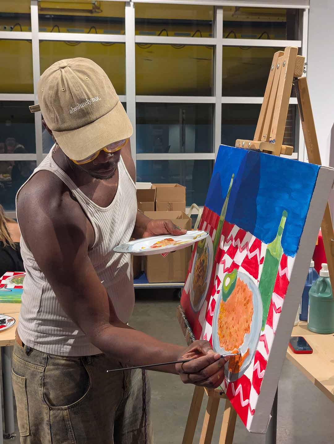 Prince painting at the Paint the Plate event.