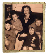A woman and four children pose in a black and white photograph.