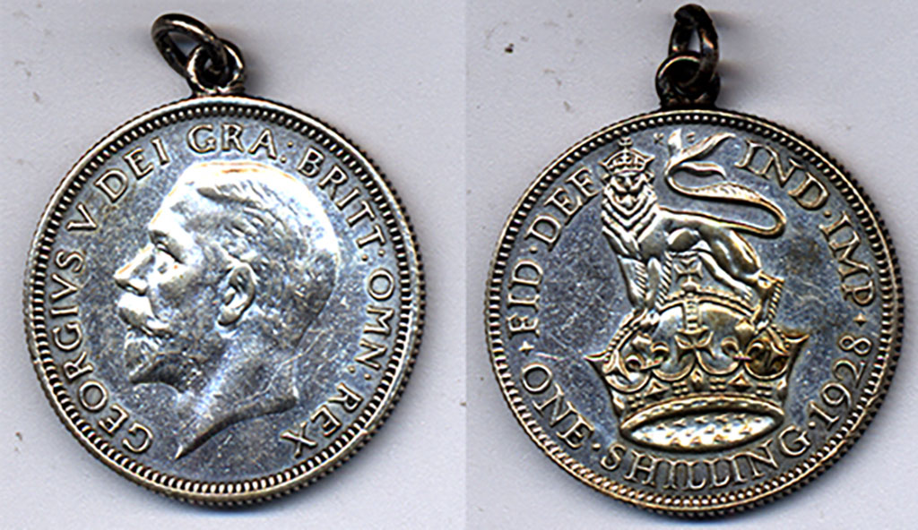 Close up of an old coin, the front etched with the profile of a man and the back etched with a lion atop a crown. There is Latin inscription on the periphery.