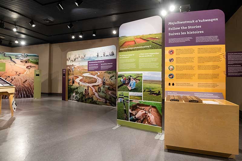 Exhibition area showing colourful panels with text and photos.