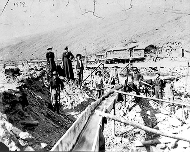 Six people stand in a gravel pit that is meant to be a mine.