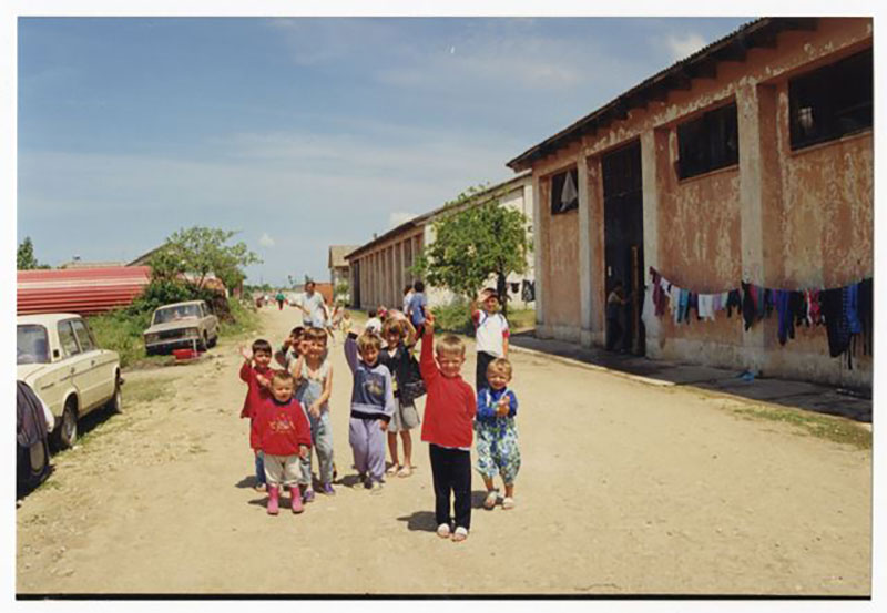 A group of children waving.