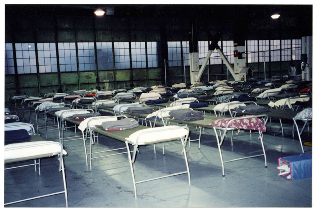 A warehouse is filled with cots.