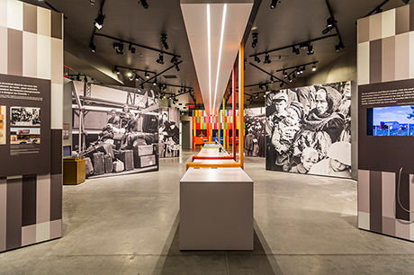 Canada immigration hall showing floor to ceiling black and white images of immigrants past.