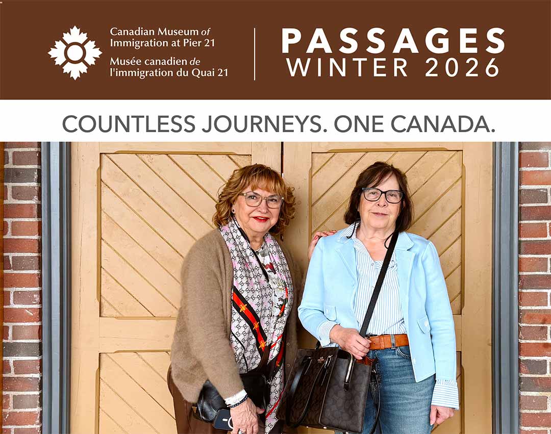 Two light-skinned women in their sixties pose in front of a pair of wooden doors.
