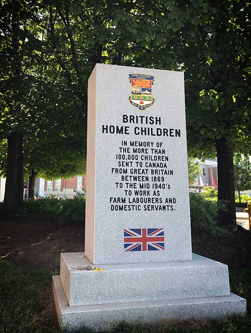 Rectangular stone monument reads British Home Children. In memory of the more than 100,000 children sent to Canada from Great Britian between 1869 to the mid 1940’s to work as farm labourers and domestic servants