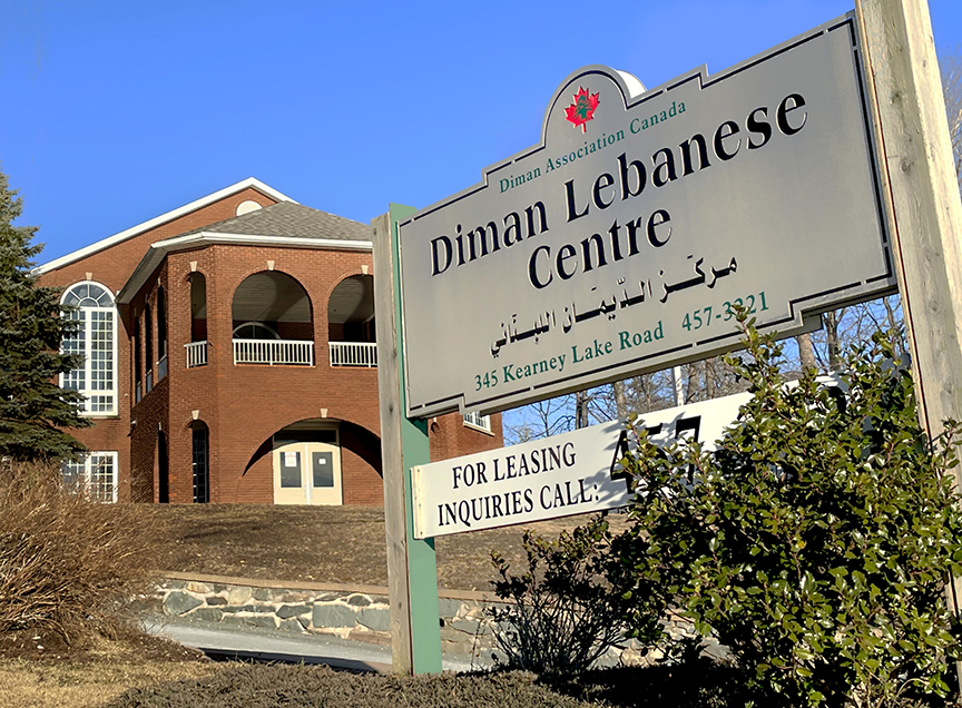 A brick two story building, with a sign that reads Diman Lebanese Centre.