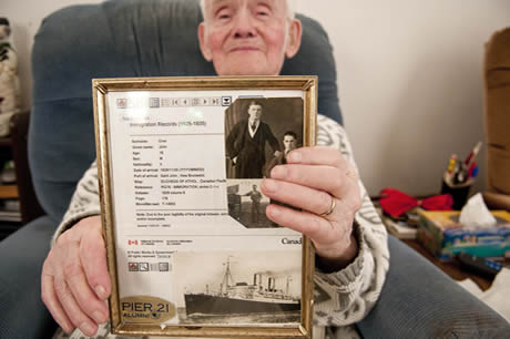 Johnny holds his framed Pier 21 Alumni photo