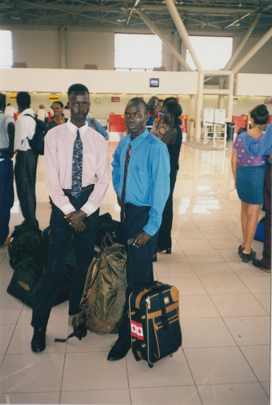 Two men in ties in an airport.