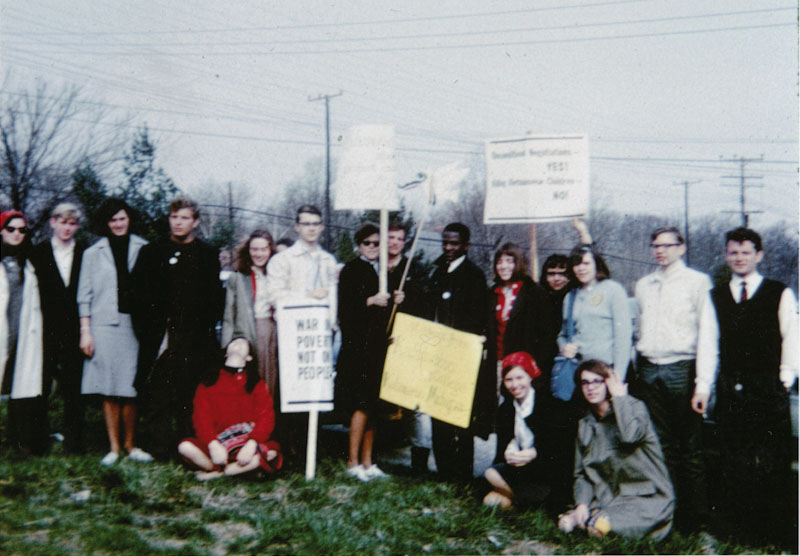 A group of people in an old photo, holding protest signs.