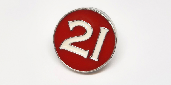 A lapel pin with the number 21 on it.