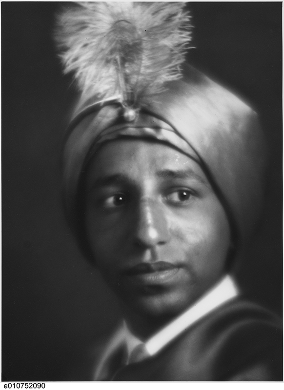 A young boy wears a fancy turban.