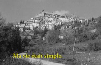 Black and white image of a small town on the hillside.