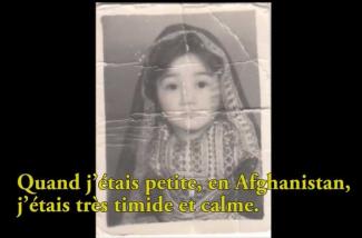 An old wrinkled photo of a small girl in a veil.