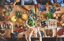 Curry, rice, seafood, salads, and breads from many cultures are laid out on a large table.