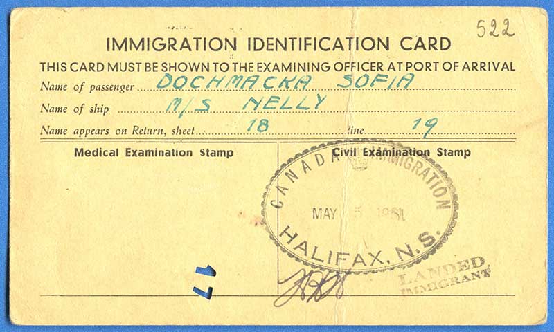 Immigration identification card with passenger and ship  name stamped on.
