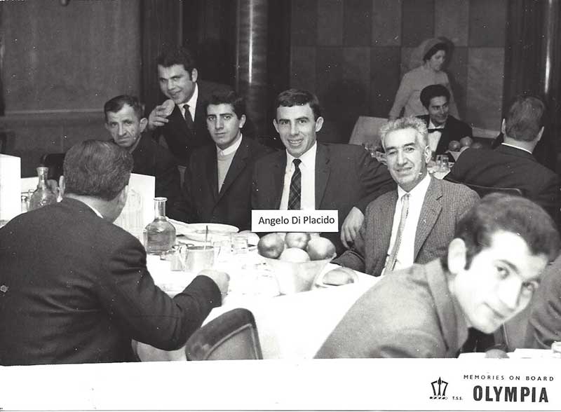 Well-dressed young men seated at a dinner table.