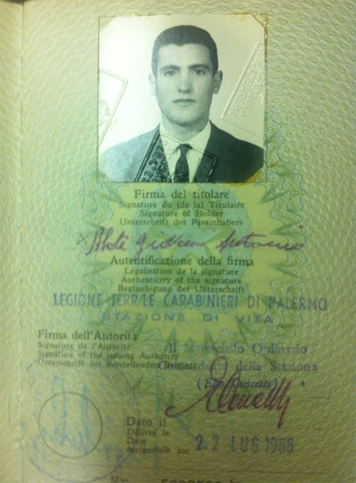 Old passport page with photo and stamp.