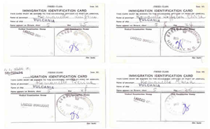 Four stamped copies of white cards reading Immigration Identification Card.