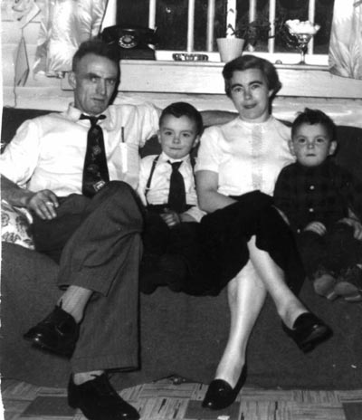 Becky and Chub with two small sons, seated on couch.