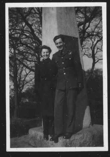 Bill and Jo as a young couple, standing in front of a monument.