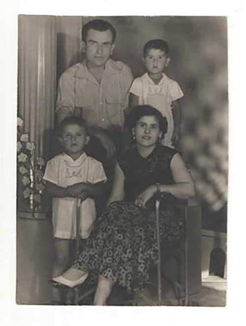 A young couple with two small children have their photo taken.