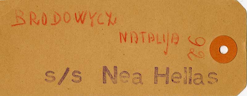 A yellow luggage tag for Natalia with the stamp of S/S Nea Hellas and number 92.