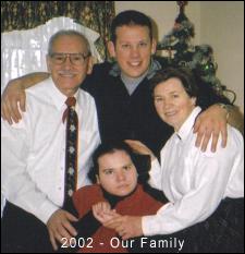 Bruno, wife and children pictured in front of Christmas tree.