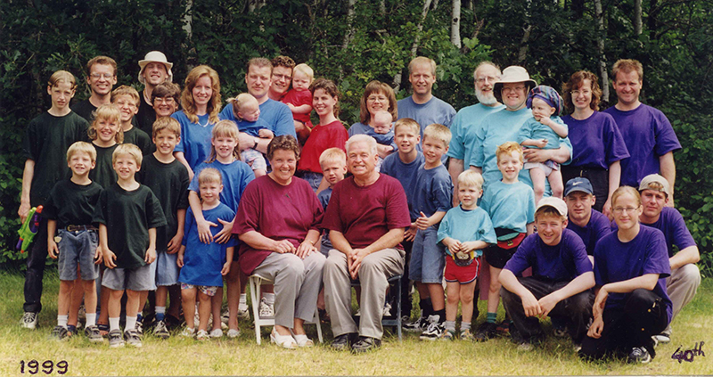 Large family photo taken outside.
