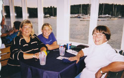 Irene, Fiona and Sarah sitting at a restaurant table with a purple tablecloth.