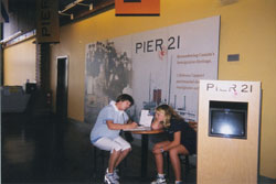 Irene and her granddaughter sitting at a table at the Pier 21 Museum.