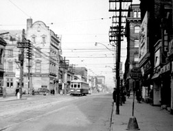 Old photo of tram car on street in Toronto.