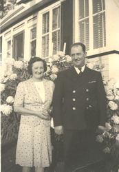 Hugh and his wife Audrey stand in front of a house.