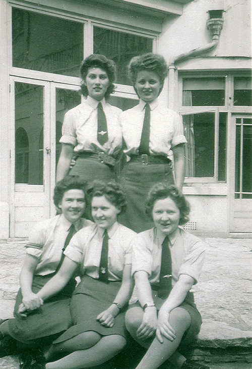 Five young woman are posing for a photograph.
