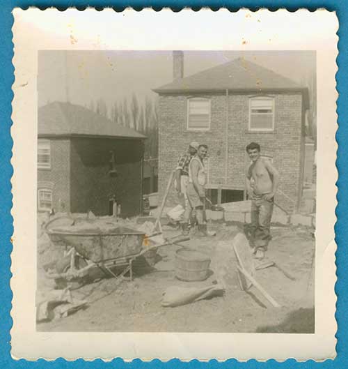 Three young men at a construction site.