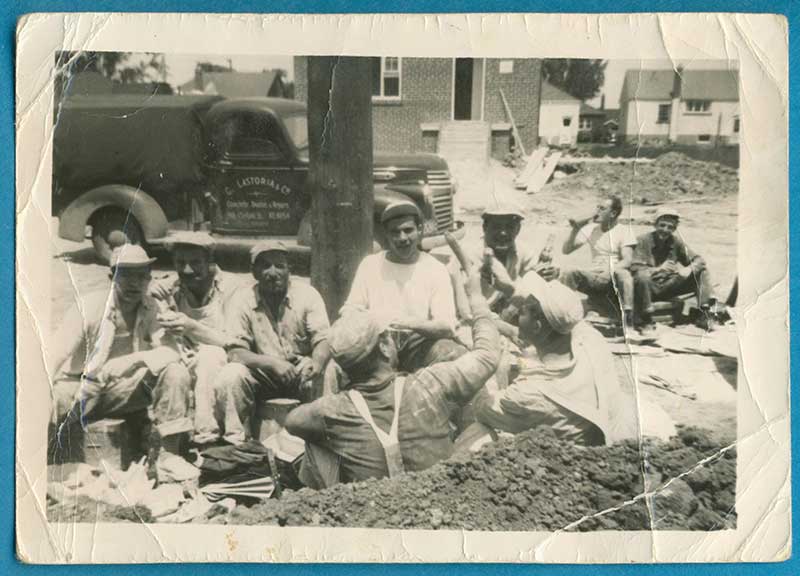 Archival image of a few young men at a construction site.